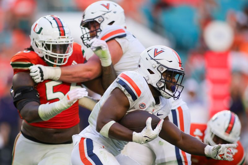 Oct 28, 2023; Miami Gardens, Florida, USA; Virginia Cavaliers wide receiver Malik Washington (4) runs with the football against the Miami Hurricanes during the fourth quarter at Hard Rock Stadium. Mandatory Credit: Sam Navarro-USA TODAY Sports