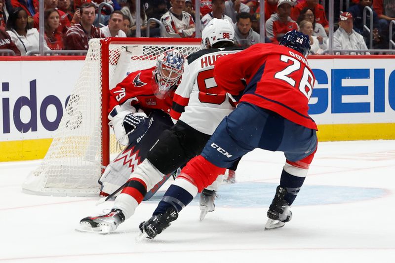 Oct 12, 2024; Washington, District of Columbia, USA; New Jersey Devils center Jack Hughes (86) shoots the puck on Washington Capitals goaltender Charlie Lindgren (79) as Capitals center Nic Dowd (26) defends in the second period at Capital One Arena. Mandatory Credit: Geoff Burke-Imagn Images