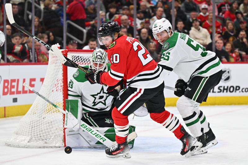Jan 13, 2024; Chicago, Illinois, USA;  Chicago Blackhawks forward Rem Pitlick (20) and Dallas Stars defenseman Thomas Harley (55) chase after a loose puck in the third period at United Center. Mandatory Credit: Jamie Sabau-USA TODAY Sports