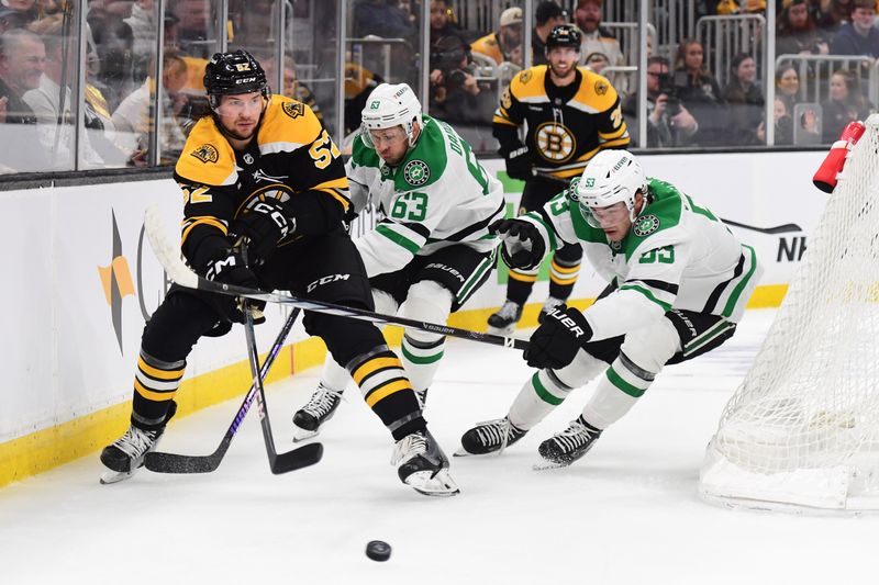 Oct 24, 2024; Boston, Massachusetts, USA;  Boston Bruins defenseman Andrew Peeke (52) passes the puck ahead of Dallas Stars right wing Evgenii Dadonov (63) and center Wyatt Johnston (53) during the second period at TD Garden. Mandatory Credit: Bob DeChiara-Imagn Images