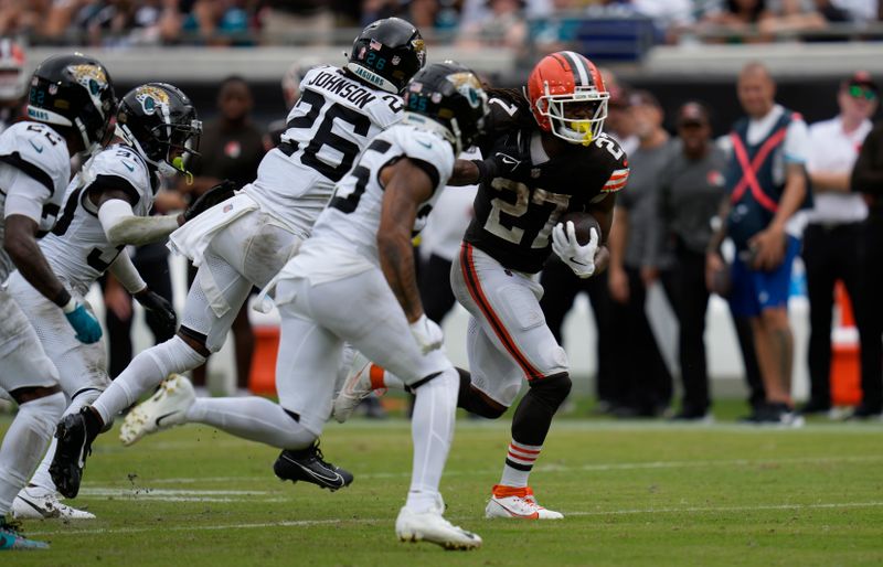 Cleveland Browns running back D'Onta Foreman (27) runs past Jacksonville Jaguars safety Antonio Johnson (26) and cornerback Ronald Darby (25) during the second half of an NFL football game Sunday, Sept. 15, 2024, in Jacksonville, Fla. (AP Photo/John Raoux)