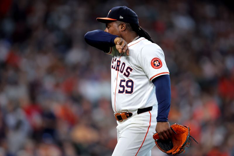 Aug 18, 2024; Houston, Texas, USA; Houston Astros starting pitcher Framber Valdez (59) reacts after retiring the side against the Chicago White Sox during the third inning at Minute Maid Park. Mandatory Credit: Erik Williams-USA TODAY Sports