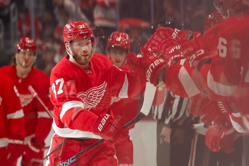 Nov 30, 2023; Detroit, Michigan, USA;  Detroit Red Wings left wing J.T. Compher (37) receives congratulations from teammates after scoring in the first period against the Chicago Blackhawks at Little Caesars Arena. Mandatory Credit: Rick Osentoski-USA TODAY Sports