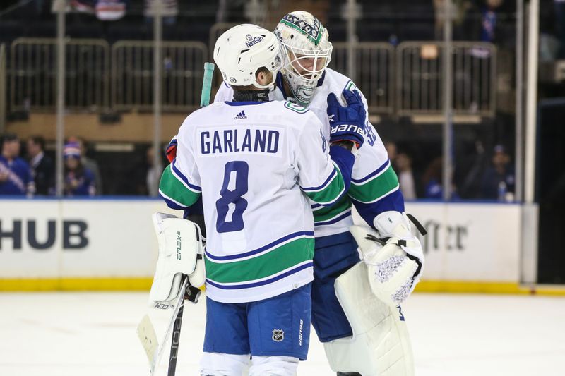 Jan 8, 2024; New York, New York, USA;  Vancouver Canucks right wing Conor Garland (8) and goaltender Thatcher Demko (35) celebrate after defeating the New York Rangers 6-3 at Madison Square Garden. Mandatory Credit: Wendell Cruz-USA TODAY Sports