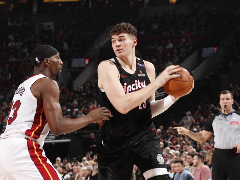 PORTLAND, OR - JANUARY 11: Donovan Clingan #23 of the Portland Trail Blazers handles the ball during the game against the Miami Heat  on January 11, 2025 at the Moda Center Arena in Portland, Oregon. NOTE TO USER: User expressly acknowledges and agrees that, by downloading and or using this photograph, user is consenting to the terms and conditions of the Getty Images License Agreement. Mandatory Copyright Notice: Copyright 2025 NBAE (Photo by Cameron Browne/NBAE via Getty Images)