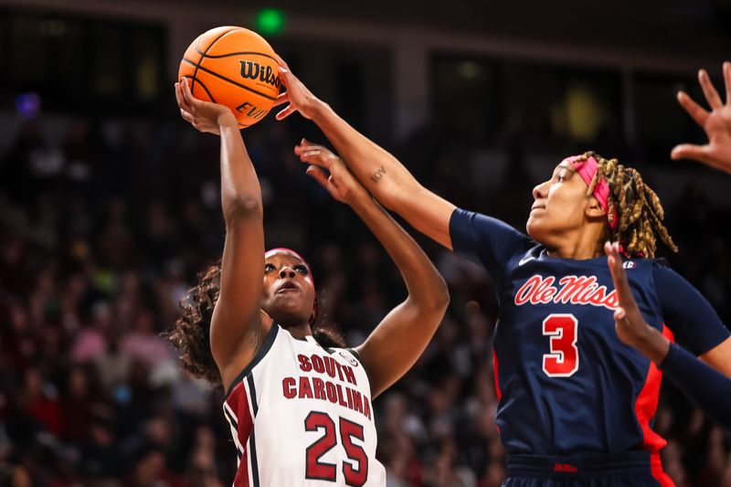 Feb 4, 2024; Columbia, South Carolina, USA; Ole Miss Rebels guard Kennedy Todd-Williams (3) blocks the shot of South Carolina Gamecocks guard Raven Johnson (25) in the first half at Colonial Life Arena. Mandatory Credit: Jeff Blake-USA TODAY Sports