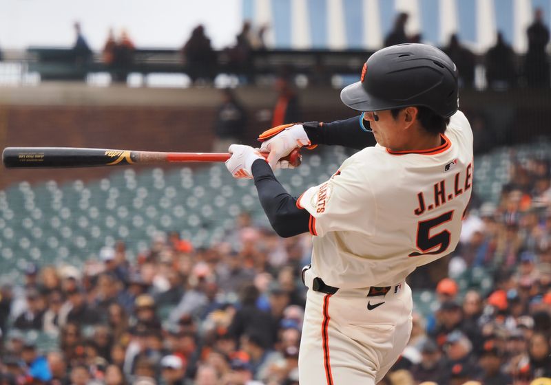Apr 24, 2025; San Francisco, California, USA;  San Francisco Giants center fielder Jung Hoo Lee (51) hits an RBI double against the Milwaukee Brewers during the first inning at Oracle Park. Mandatory Credit: Kelley L Cox-Imagn Images