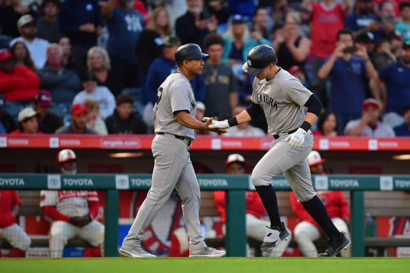 May 27, 2025; Anaheim, California, USA; New York Yankees designated hitter Ben Rice (22) is greeted by third base coach Luis Rojas (67) after hitting a solo home run against the Los Angeles Angels during the fourth inning at Angel Stadium. Mandatory Credit: Gary A. Vasquez-Imagn Images