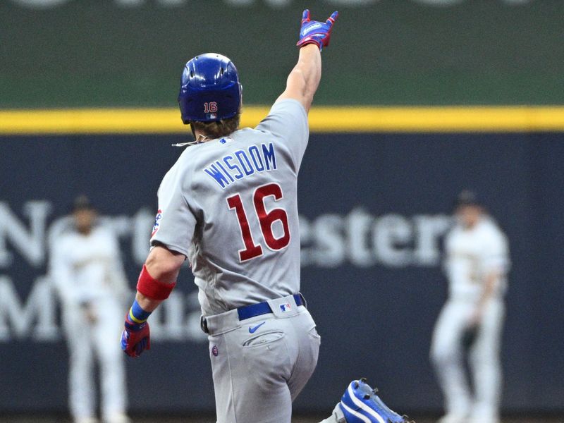 Sep 30, 2023; Milwaukee, Wisconsin, USA; Chicago Cubs third baseman Patrick Wisdom (16) celebrates hitting a home run against the Milwaukee Brewers in the first inning at American Family Field. Mandatory Credit: Michael McLoone-USA TODAY Sports