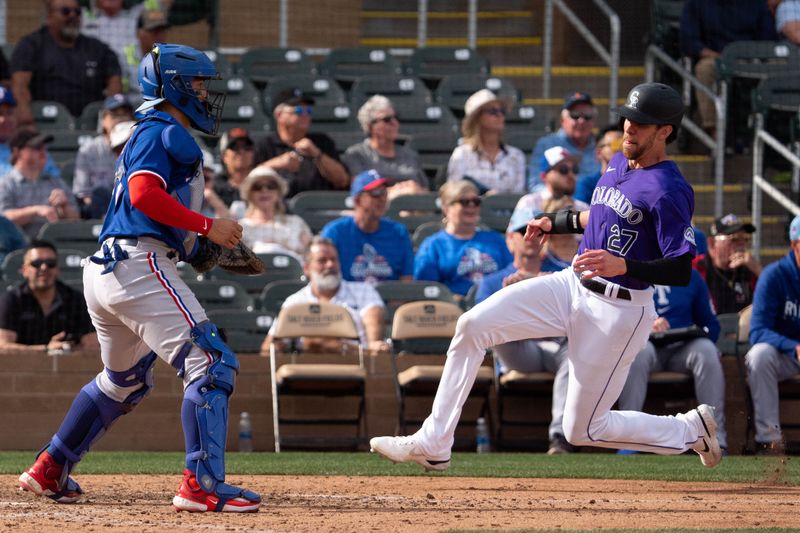 Mar 6, 2024; Salt River Pima-Maricopa, Arizona, USA; Colorado Rockies outfielder Bradley Zimmer (27) slides in to score in the eighth as Texas Rangers catcher Braxton Fulford (71) awaits the ball during a spring training game at Salt River Fields at Talking Stick. Mandatory Credit: Allan Henry-USA TODAY Sports