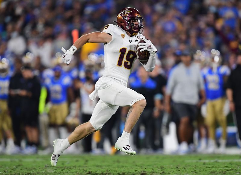 Oct 2, 2021; Pasadena, California, USA; Arizona State Sun Devils wide receiver Ricky Pearsall (19) runs the ball for a touchdown against the UCLA Bruins during the first half at Rose Bowl. Mandatory Credit: Gary A. Vasquez-USA TODAY Sports