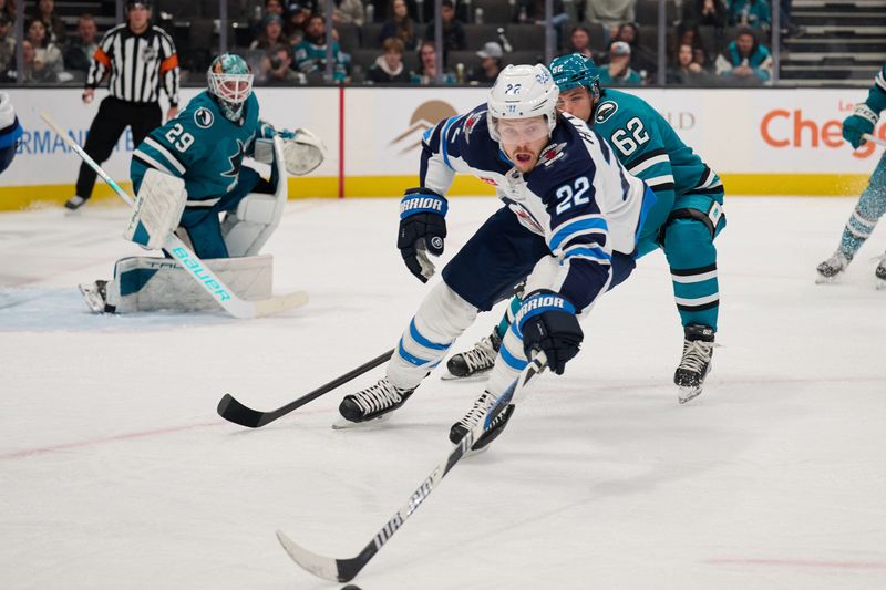 Dec 12, 2023; San Jose, California, USA; Winnipeg Jets center Mason Appleton (22) extends for the puck with his stick against San Jose Sharks right wing Kevin Labanc (62)  during the third period at SAP Center at San Jose. Mandatory Credit: Robert Edwards-USA TODAY Sports