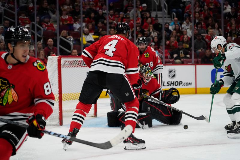 Oct 4, 2024; Chicago, Illinois, USA; Chicago Blackhawks goaltender Petr Mrazek (34) makes a save against the Minnesota Wild during the second period at United Center. Mandatory Credit: David Banks-Imagn Images