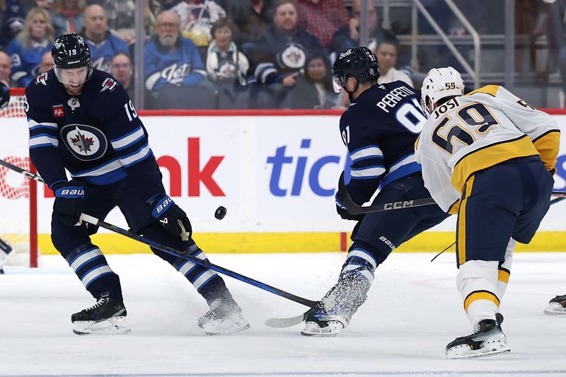 Jan 7, 2025; Winnipeg, Manitoba, CAN; Winnipeg Jets center David Gustafsson (19) blocks a shot by Nashville Predators defenseman Roman Josi (59) in the second period at Canada Life Centre. Mandatory Credit: James Carey Lauder-Imagn Images