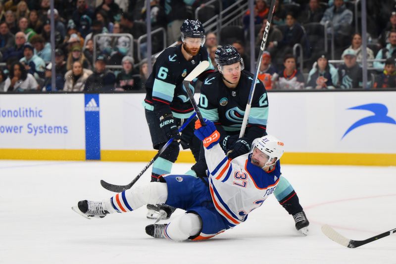 Mar 2, 2024; Seattle, Washington, USA; Seattle Kraken right wing Eeli Tolvanen (20) collides with Edmonton Oilers left wing Warren Foegele (37) during the third period at Climate Pledge Arena. Mandatory Credit: Steven Bisig-USA TODAY Sports