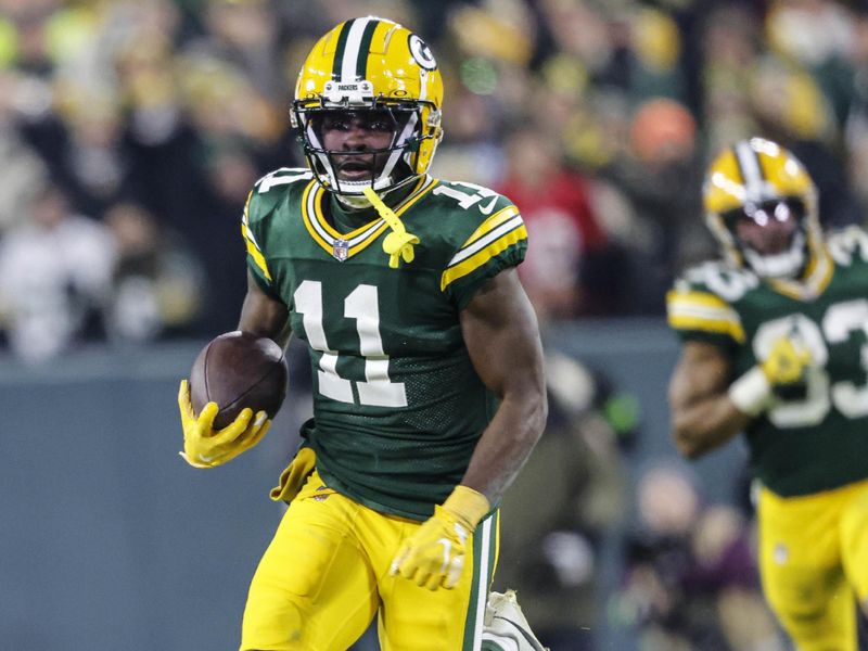 Green Bay Packers wide receiver Jayden Reed (11) runs with the ball during an NFL football game against the Chicago Bears Sunday, Jan. 7, 2024, in Green Bay, Wis. (AP Photo/Jeffrey Phelps