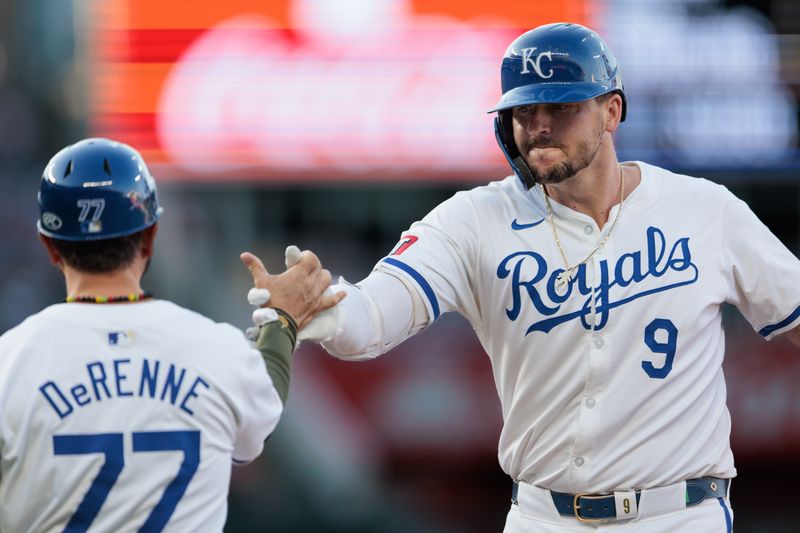 May 18, 2024; Kansas City, Missouri, USA; Kansas City Royals first base Vinnie Pasquantino (9) slaps hands with the first base coach after a single during the fifth inning against the Oakland Athletics at Kauffman Stadium. Mandatory Credit: William Purnell-USA TODAY Sports