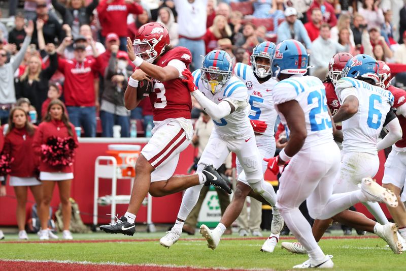 Nov 2, 2024; Fayetteville, Arkansas, USA; Arkansas Razorbacks quarterback Malchi Singleton (3) rushes for a touchdown in the third quarter against the Ole Miss Rebels at Donald W. Reynolds Razorback Stadium. Mississippi won 63-31. Mandatory Credit: Nelson Chenault-Imagn Images