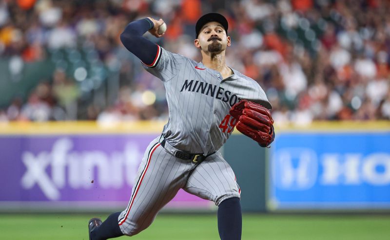 May 31, 2024; Houston, Texas, USA; Minnesota Twins starting pitcher Pablo Lopez (49) delivers a pitch during the second inning against the Houston Astros at Minute Maid Park. Mandatory Credit: Troy Taormina-USA TODAY Sports