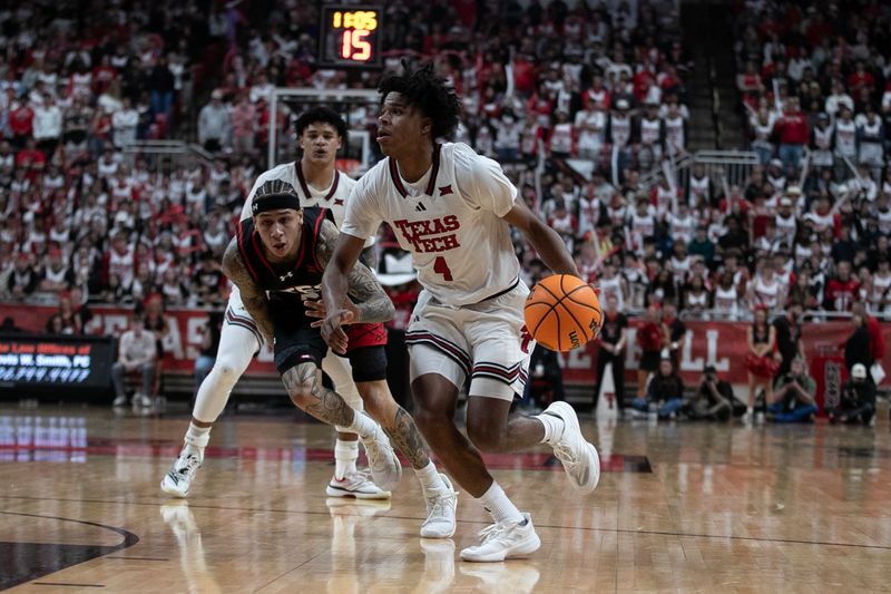 Jan 14, 2026; Lubbock, Texas, USA;  Texas Tech Red Raiders guard Christian Anderson (4) drives the ball against  Utah Utes guard Terrence Brown (2) in the section half at United Supermarkets Arena. Mandatory Credit: Michael C. Johnson-Imagn Images