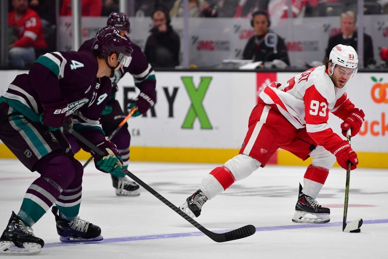 Jan 7, 2024; Anaheim, California, USA; Detroit Red Wings right wing Alex DeBrincat (93) moves the puck ahead of Anaheim Ducks defenseman Cam Fowler (4) during the third period at Honda Center. Mandatory Credit: Gary A. Vasquez-USA TODAY Sports