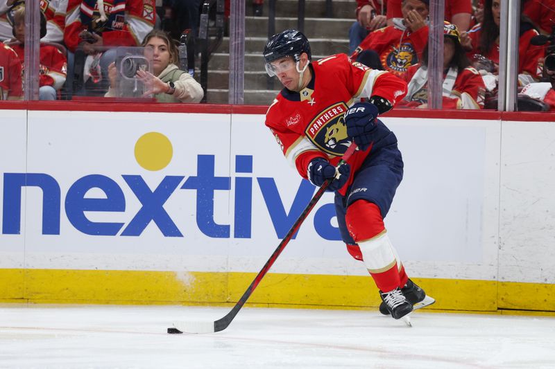 Apr 26, 2025; Sunrise, Florida, USA; Florida Panthers center Evan Rodrigues (17) controls the puck against the Tampa Bay Lightning in the second period during game three of the first round of the 2025 Stanley Cup Playoffs at Amerant Bank Arena. Mandatory Credit: Nathan Ray Seebeck-Imagn Images