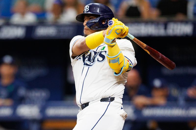 May 21, 2024; St. Petersburg, Florida, USA;  Tampa Bay Rays third base Isaac Paredes (17) hits a two rbi single against the Boston Red Sox in the first inning at Tropicana Field. Mandatory Credit: Nathan Ray Seebeck-USA TODAY Sports