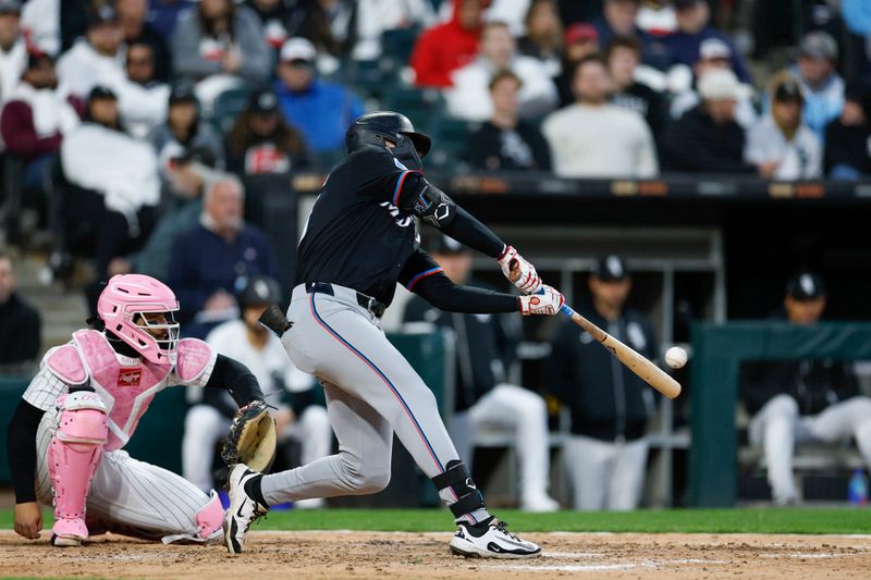 May 10, 2025; Chicago, Illinois, USA; Miami Marlins left fielder Kyle Stowers (28) hits a solo home run against the Chicago White Sox during the seventh inning at Rate Field. Mandatory Credit: Kamil Krzaczynski-Imagn Images