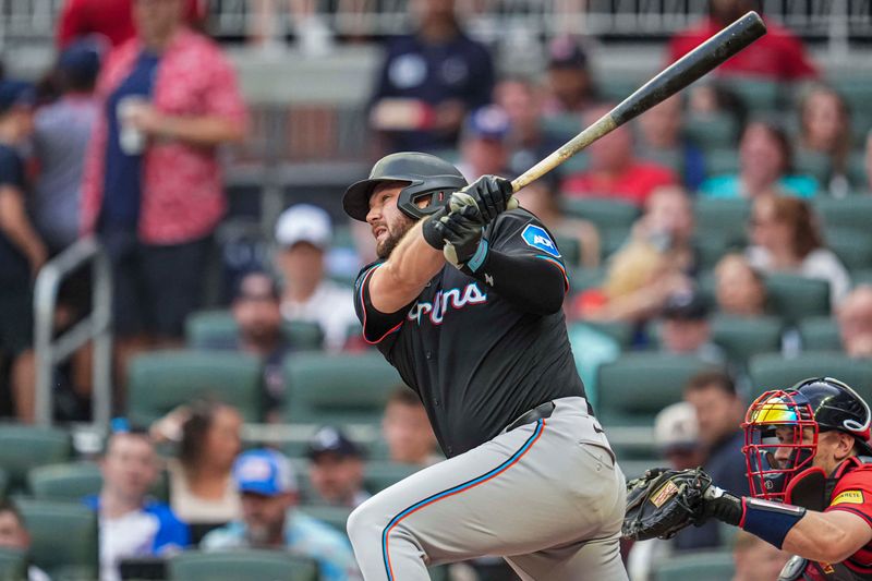 Aug 2, 2024; Cumberland, Georgia, USA; Miami Marlins designated hitter Jake Burger (36) hits a home run against the Atlanta Braves during the third inning at Truist Park. Mandatory Credit: Dale Zanine-USA TODAY Sports