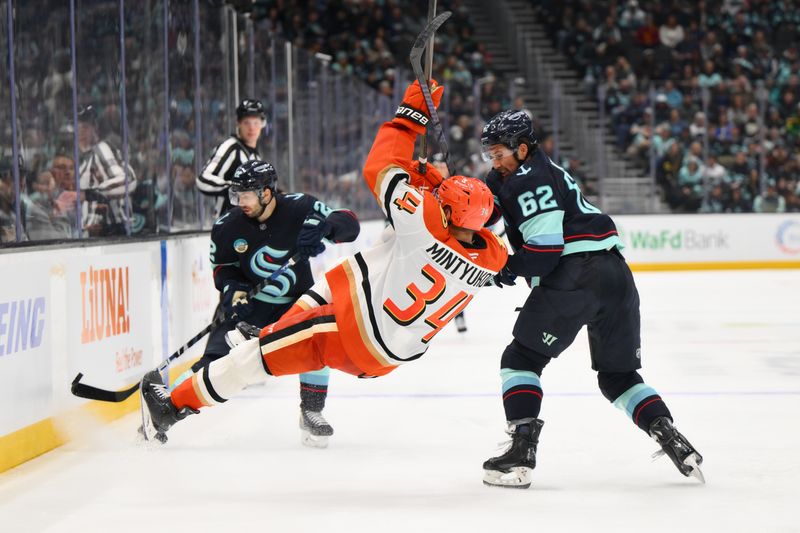 Nov 27, 2024; Seattle, Washington, USA; Seattle Kraken defenseman Brandon Montour (62) checks Anaheim Ducks defenseman Pavel Mintyukov (34) during the third period at Climate Pledge Arena. Mandatory Credit: Steven Bisig-Imagn Images