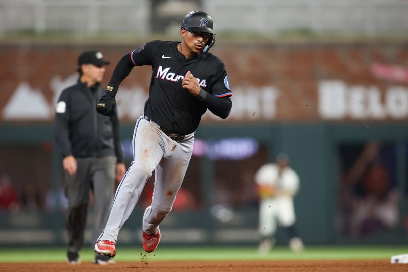 Apr 24, 2024; Atlanta, Georgia, USA; Miami Marlins catcher Christian Bethancourt (25) runs to third against the Atlanta Braves in the tenth inning at Truist Park. Mandatory Credit: Brett Davis-USA TODAY Sports