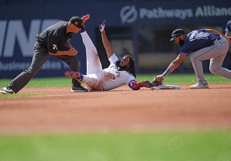 May 18, 2024; Toronto, Ontario, CAN; Toronto Blue Jays first base Vladimir Guerrero Jr. (27) is safe at second base after hitting a double during the fourth inning against the Tampa Bay Rays at Rogers Centre. Mandatory Credit: Nick Turchiaro-USA TODAY Sports