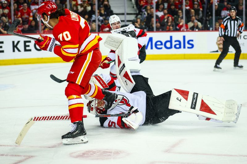Jan 19, 2026; Calgary, Alberta, CAN; New Jersey Devils goaltender Jacob Markstrom (25) makes a save against Calgary Flames left wing Ryan Lomberg (70) during the second period at Scotiabank Saddledome. Mandatory Credit: Sergei Belski-Imagn Images