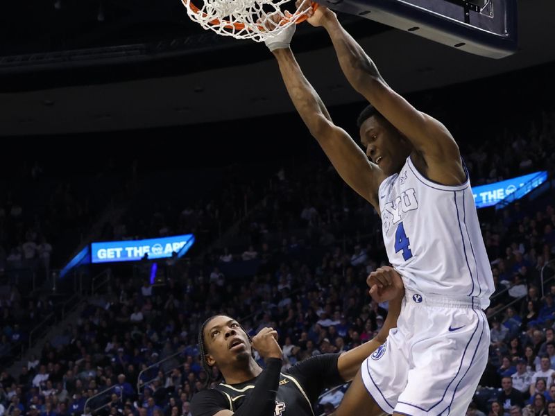 Feb 13, 2024; Provo, Utah, USA; Brigham Young Cougars forward Atiki Ally Atiki (4) dunks against Central Florida Knights forward Omar Payne (5) during the second half at Marriott Center. Mandatory Credit: Rob Gray-USA TODAY Sports