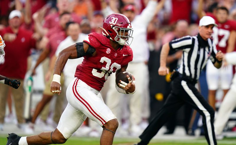 Oct 21, 2023; Tuscaloosa, Alabama, USA; Alabama Crimson Tide linebacker Jihaad Campbell (30) picks up a fumble and ran it back for a touchdown against the Tennessee Volunteers during the second half at Bryant-Denny Stadium. Mandatory Credit: John David Mercer-USA TODAY Sports