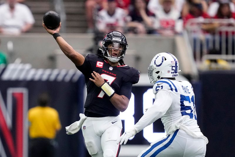 Houston Texans quarterback C.J. Stroud (7) passes over Indianapolis Colts defensive end Kwity Paye (51) during the second half of an NFL football game, Sunday, Oct. 27, 2024, in Houston. (AP Photo/Tony Gutierrez)