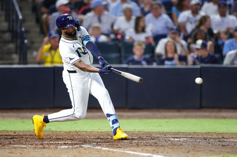 May 26, 2025; Tampa, Florida, USA; Tampa Bay Rays third baseman Junior Caminero (13) doubles against the Minnesota Twins in the sixth inning at George M. Steinbrenner Field. Mandatory Credit: Nathan Ray Seebeck-Imagn Images