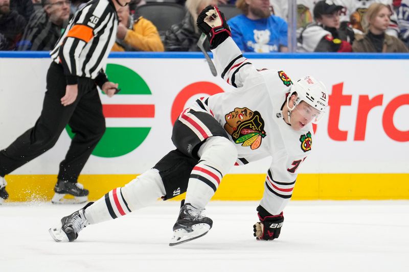 Dec 2, 2024; Toronto, Ontario, CAN; Chicago Blackhawks forward Taylor Hall (71) tries to regain his balance against the Toronto Maple Leafs during the second period at Scotiabank Arena. Mandatory Credit: John E. Sokolowski-Imagn Images