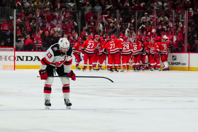 May 11, 2023; Raleigh, North Carolina, USA; New Jersey Devils center Nico Hischier (13) reacts after their loss against the Carolina Hurricanes in overtime in game five of the second round of the 2023 Stanley Cup Playoffs at PNC Arena. Mandatory Credit: James Guillory-USA TODAY Sports