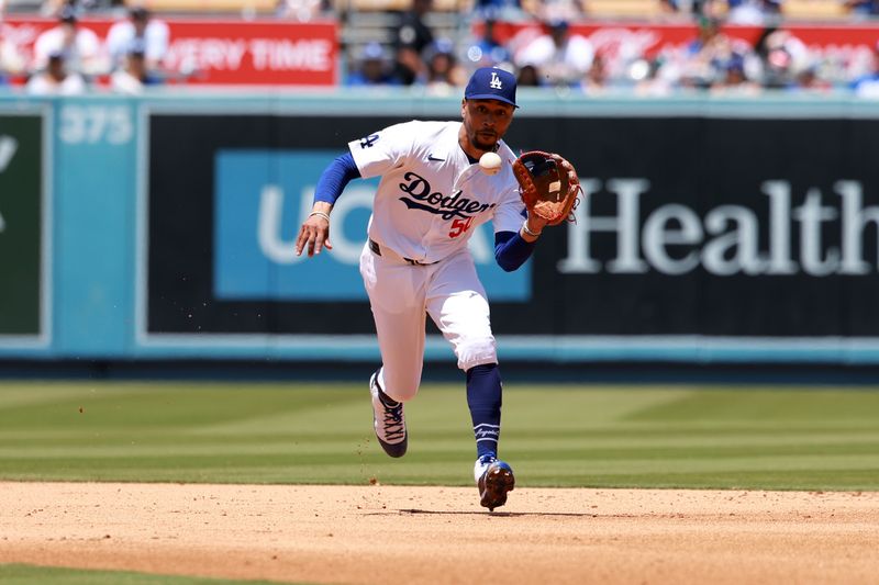 May 8, 2024; Los Angeles, California, USA;  Los Angeles Dodgers shortstop Mookie Betts (50) fields a ground ball during the seventh inning against the Miami Marlins at Dodger Stadium. Mandatory Credit: Kiyoshi Mio-USA TODAY Sports