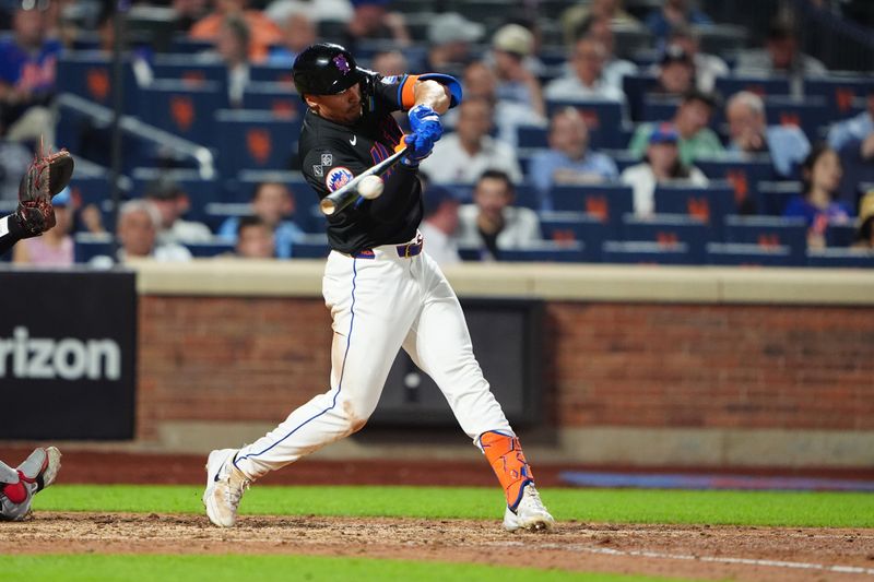 Jul 10, 2024; New York City, New York, USA; New York Mets center fielder Tyrone Taylor (15) hits a RBI triple against the Washington Nationals during the eighth inning at Citi Field. Mandatory Credit: Gregory Fisher-USA TODAY Sports