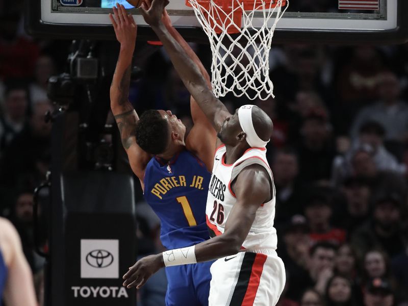 PORTLAND, OREGON - FEBRUARY 23: Duop Reath #26 of the Portland Trail Blazers blocks a shot by Michael Porter Jr. #1 of the Denver Nuggets during the first quarter at Moda Center on February 23, 2024 in Portland, Oregon. NOTE TO USER: User expressly acknowledges and agrees that, by downloading and or using this photograph, User is consenting to the terms and conditions of the Getty Images License Agreement.? (Photo by Amanda Loman/Getty Images)