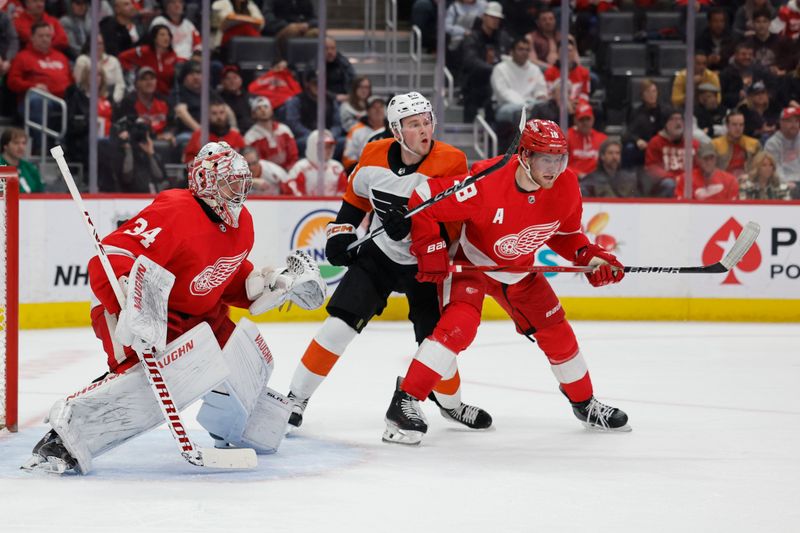 Jan 25, 2024; Detroit, Michigan, USA;  Philadelphia Flyers right wing Olle Lycksell (62) and Detroit Red Wings center Andrew Copp (18) fight for position in front of Detroit Red Wings goaltender Alex Lyon (34) in the first period at Little Caesars Arena. Mandatory Credit: Rick Osentoski-USA TODAY Sports