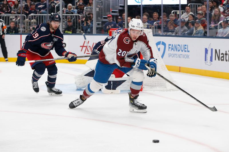 Oct 16, 2025; Columbus, Ohio, USA; Colorado Avalanche center Ross Colton (20) skates after a loose puck as Columbus Blue Jackets center Adam Fantilli (19) trails the play during the first period at Nationwide Arena. Mandatory Credit: Russell LaBounty-Imagn Images