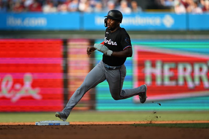 Jun 27, 2024; Philadelphia, Pennsylvania, USA; Miami Marlins outfielder Jesus Sanchez (12) rounds second base and advances to third against the Philadelphia Phillies in the second inning at Citizens Bank Park. Mandatory Credit: Kyle Ross-USA TODAY Sports