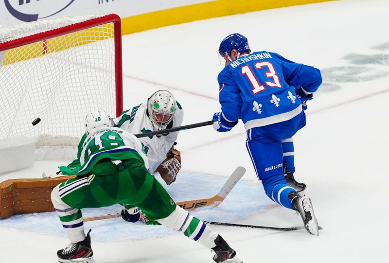 Oct 23, 2025; Denver, Colorado, USA; Colorado Avalanche right wing Valeri Nichushkin (13) scores over Carolina Hurricanes goaltender Frederik Andersen (31) and left wing Jordan Martinook (48) in the third period at Ball Arena. Mandatory Credit: Ron Chenoy-Imagn Images