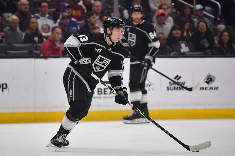 Mar 11, 2024; Los Angeles, California, USA; Los Angeles Kings defenseman Jacob Moverare (43) controls the puck against the New York Islanders during the first period at Crypto.com Arena. Mandatory Credit: Gary A. Vasquez-USA TODAY Sports