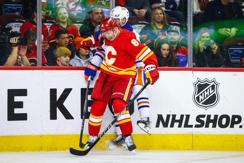 Nov 3, 2024; Calgary, Alberta, CAN; Calgary Flames defenseman Tyson Barrie (8) checks into the boards Edmonton Oilers left wing Drake Caggiula (8) during the first period at Scotiabank Saddledome. Mandatory Credit: Sergei Belski-Imagn Images