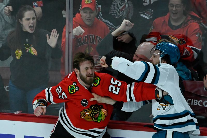 Jan 16, 2024; Chicago, Illinois, USA; San Jose Sharks right wing Scott Sabourin (49) and Chicago Blackhawks defenseman Jarred Tinordi (25) fight during the second period at United Center. Mandatory Credit: Matt Marton-USA TODAY Sports