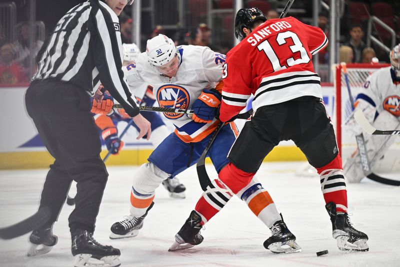 Jan 19, 2024; Chicago, Illinois, USA; New York Islanders forward Kyle MacLean (32) takes his first NHL face off in the first period against Chicago Blackhawks forward Zach Sanford (13) at United Center. Mandatory Credit: Jamie Sabau-USA TODAY Sports